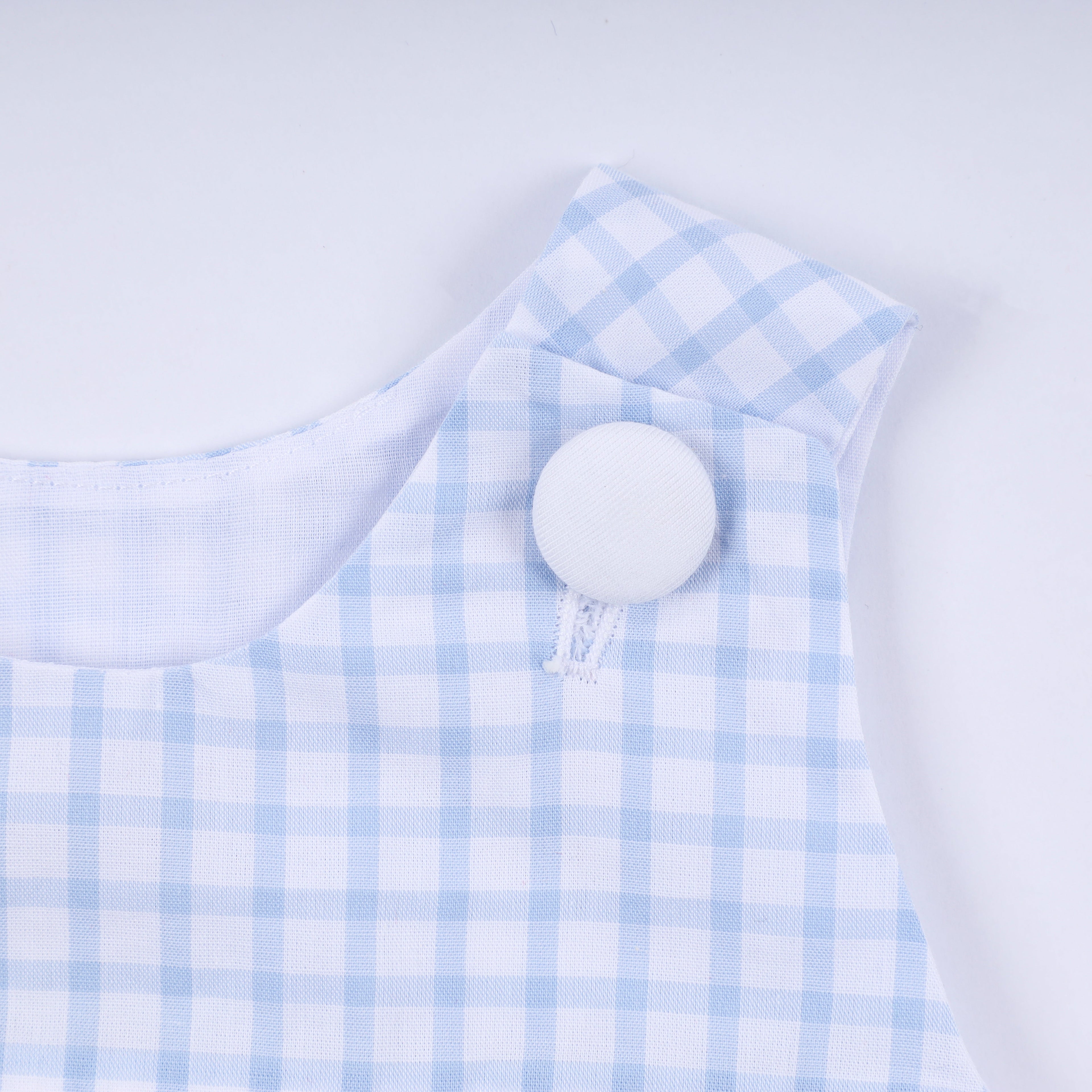 Blue character hand smocked gingham bubble