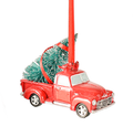 Red Pickup Truck brings home the tree